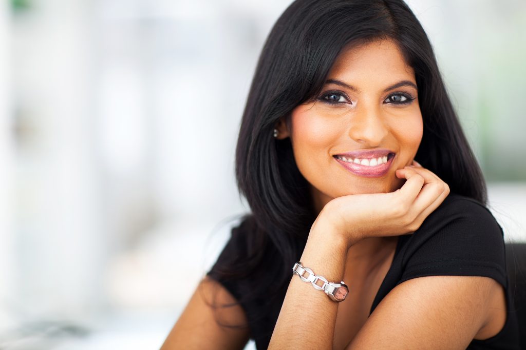 Woman smiling, embodying the advancements in hormone therapy and revolutionary peptide therapies